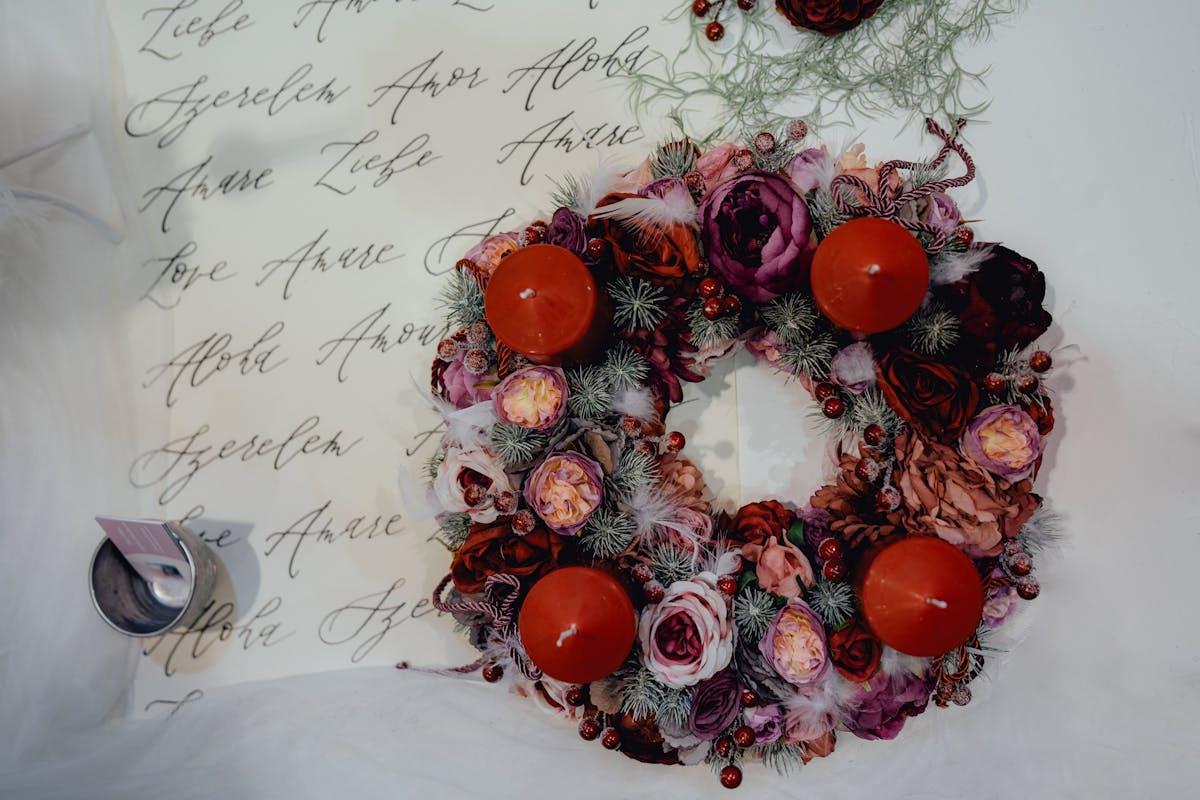 Holiday floral centerpiece with red roses, pine, and berries on a decorated Christmas table in Sedalia, MO