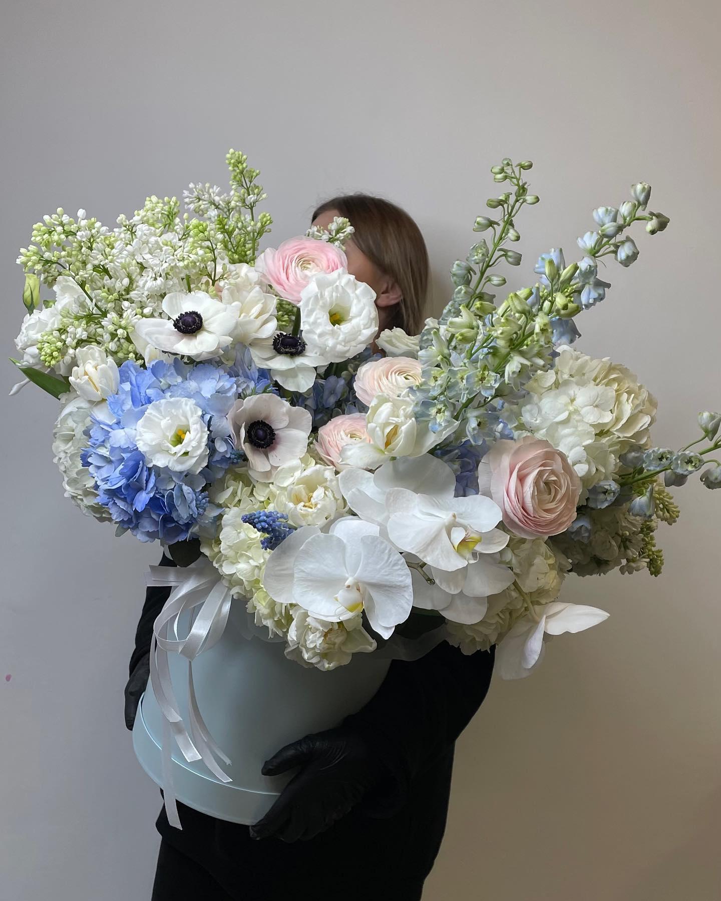 Mixed seasonal bouquet with roses and greenery arranged by a Sedalia florist