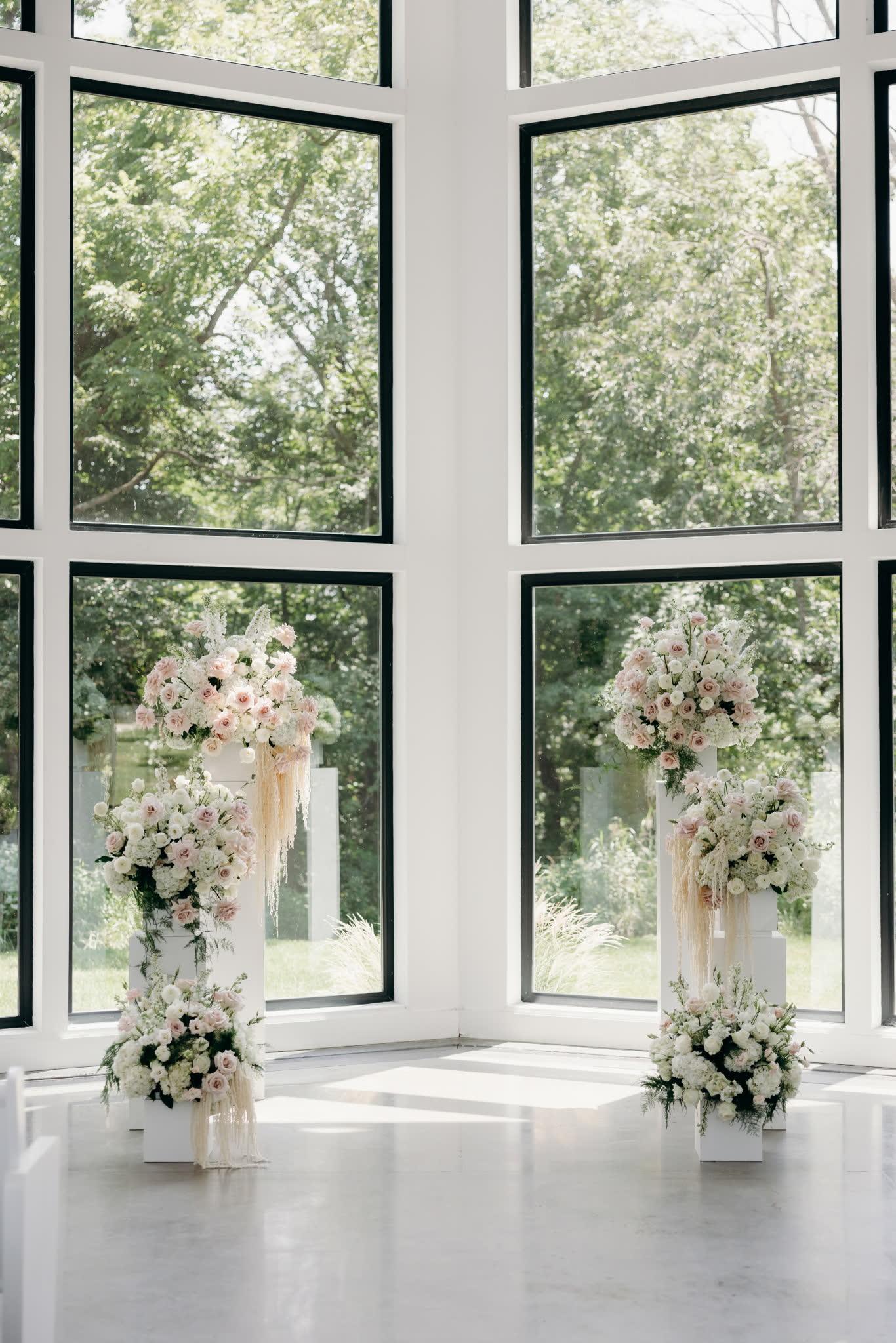 Paired tall pedestal arrangements in a corner window