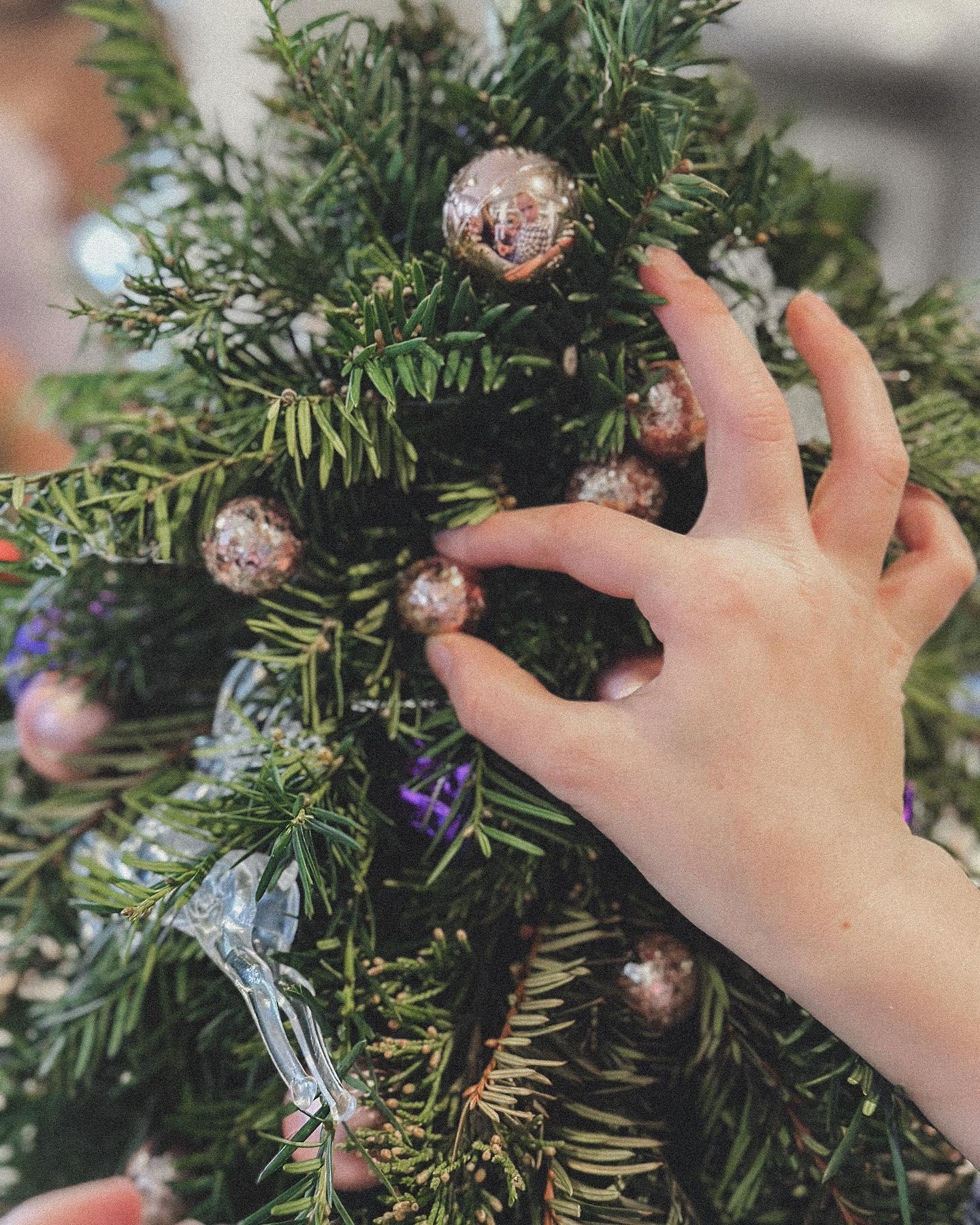 Holiday wreath-making workshop with rows of children crafting at a community event