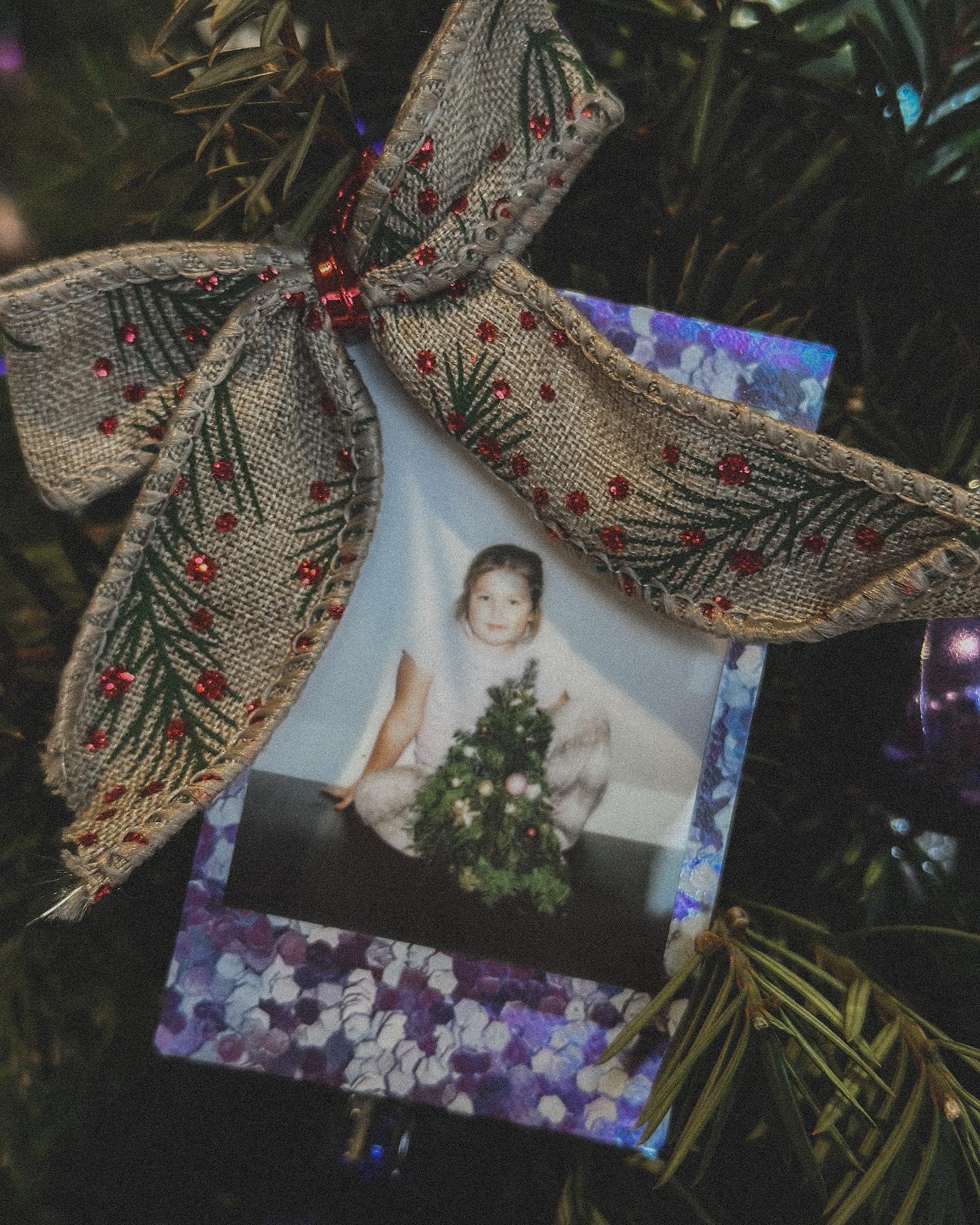 Close-up of child's hands selecting decorations for Christmas wreath at kids floral workshop