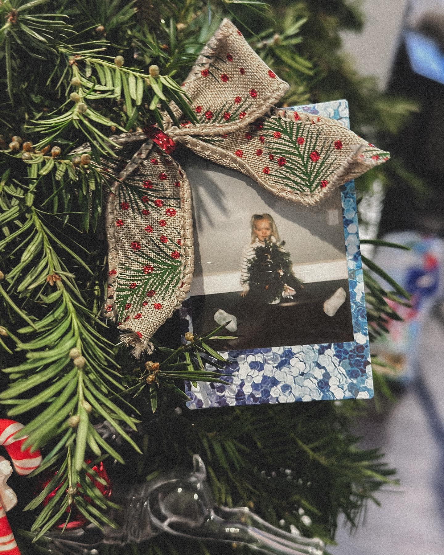 Young students focused on creating holiday wreaths with greenery and mixed ornaments