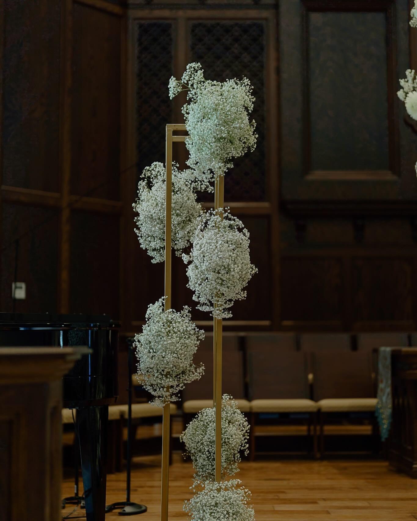 Baby's breath cloud arrangements on gold stands for church wedding ceremony — Sedalia, MO